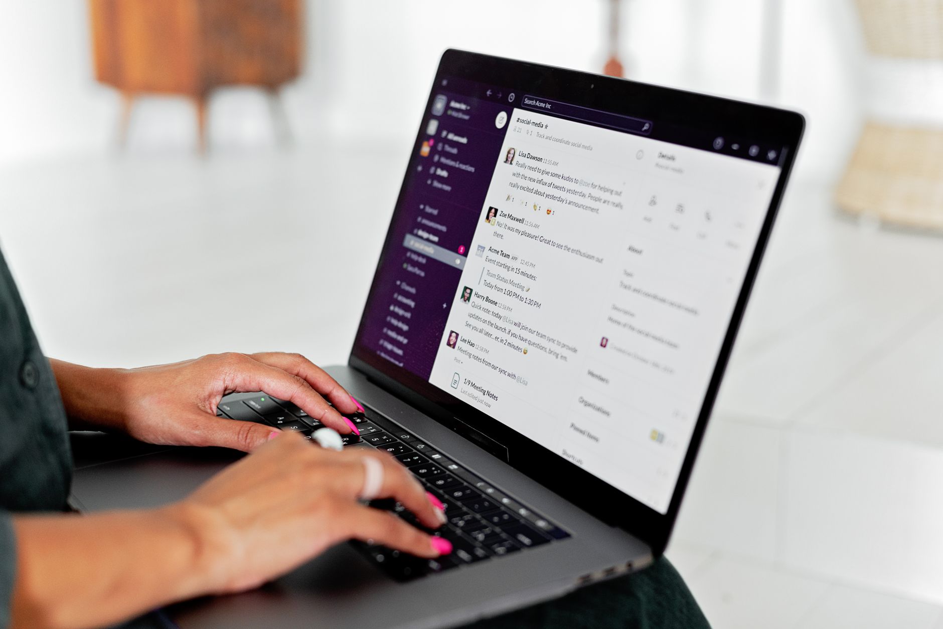 A close-up of a person using a laptop trackpad to delete a chat conversation from an AI application.